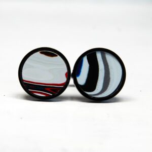 Colorful, round abstract design earrings on display.
