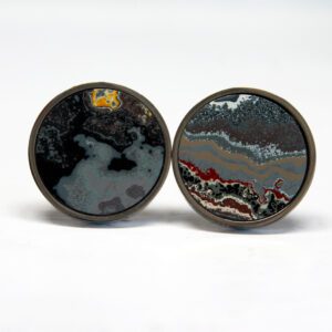 Round stone cufflinks with abstract patterns.