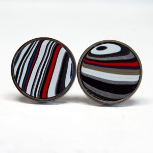 Colorful striped circular cufflinks on display.