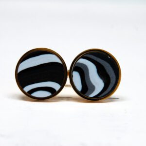Black and white striped circular earrings.