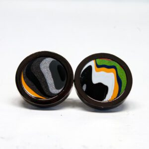 Colorful abstract design earrings on white background.
