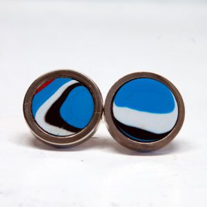 Colorful round cufflinks on white background.