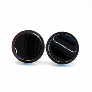 Two black circular stones on white background.