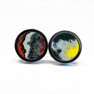 Colorful abstract design cufflinks on white background.