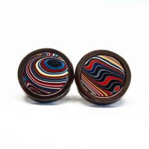 Colorful swirl-patterned round cufflinks on white.