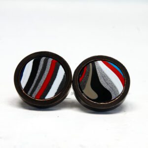 Colorful round cufflinks with striped pattern.