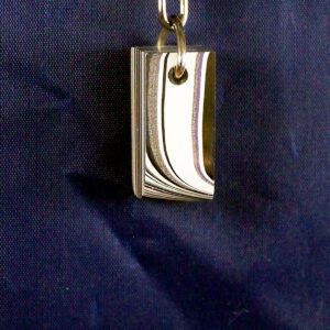 Silver pendant on a dark blue background.