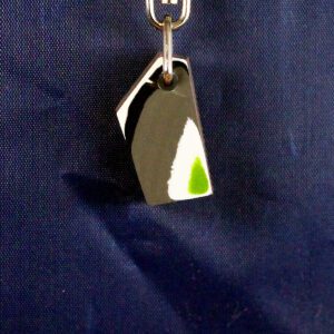 Abstract pendant with geometric design on hook.