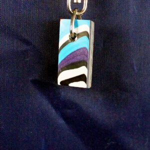 Colorful keychain on dark blue background.