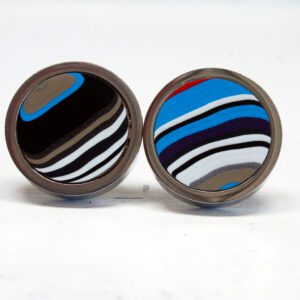 Colorful round striped cufflinks on display.