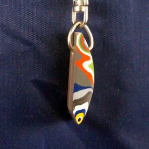 Colorful abstract keychain on a blue background.