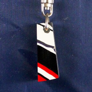 Colorful patterned keychain on dark background.