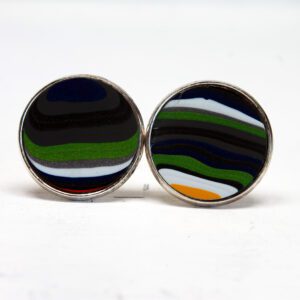 Colorful striped round cufflinks on display.
