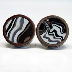 Circular cufflinks with black and white swirls.