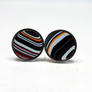 Striped round earrings on white background.