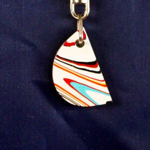 Colorful striped pendant against dark blue background.