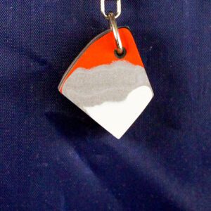 Tri-color pendant on a blue background.