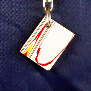 Colorful keychain on dark blue background.