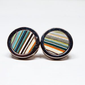 Colorful striped cufflinks on white background.