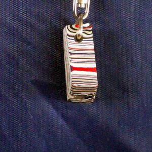 Striped keychain against a dark blue background.