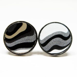 Two round black and white earrings.