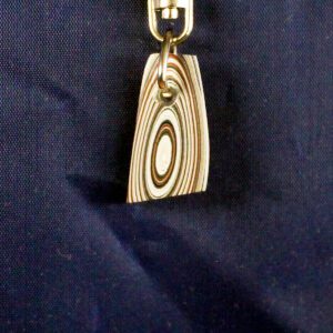 Colorful layered paper pendant on blue background.