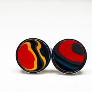 Colorful abstract cufflinks on white background.