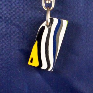 Colorful striped keychain on blue background.