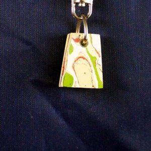 Abstract-patterned pendant on dark blue background.