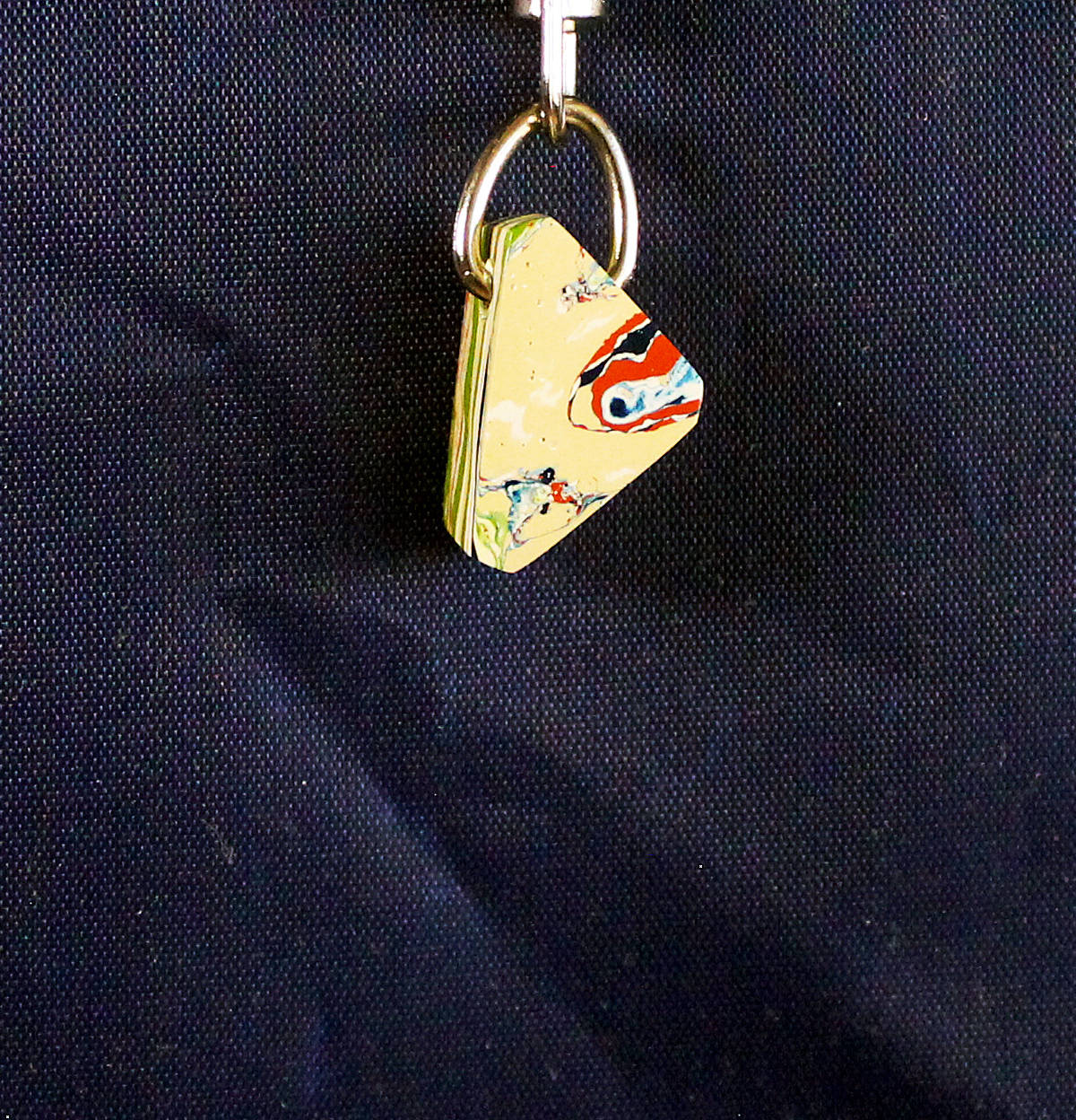 Colorful keychain with abstract design on fabric.