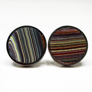 Striped circular cufflinks with colorful patterns.