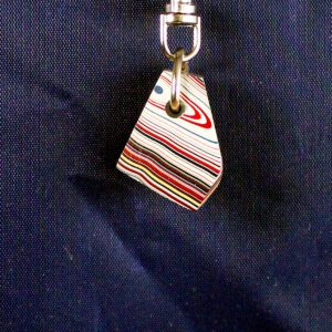 Colorful striped keychain against dark background.