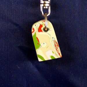 Colorful abstract keychain on dark background.