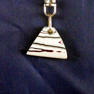 Triangular pendant with red and black stripes.