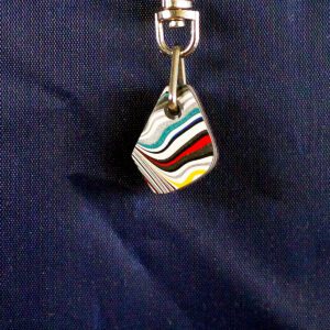 Colorful pendant with abstract striped design.