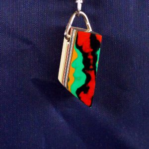 Colorful pendant with abstract design on blue.
