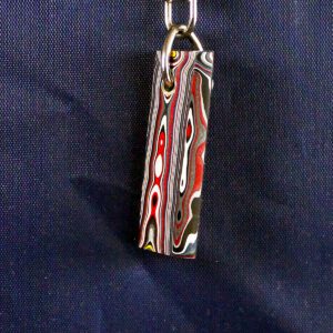 Colorful pendant with swirling pattern design.