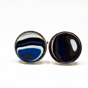 Round cufflinks with abstract blue design.