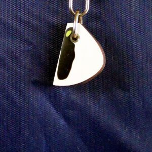 Keychain with abstract design on blue background.