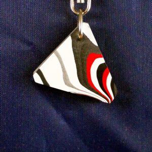 Triangular keychain with abstract pattern design.