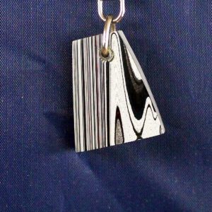 Striped keychain pendant on blue background.