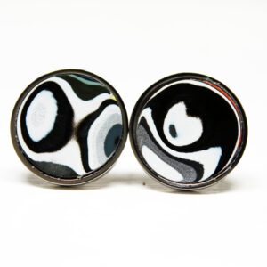 Black and white round cufflinks, abstract design.