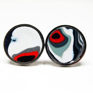 Two circular, abstract patterned earrings.