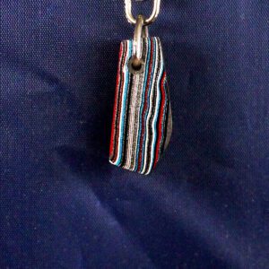 Striped keychain pendant against blue background.