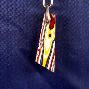 Colorful pendant on a dark blue background.