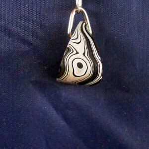 Black and white teardrop pendant on hook.