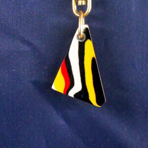 Triangle keychain with colorful abstract pattern.