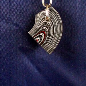 Striped keychain pendant on blue background.