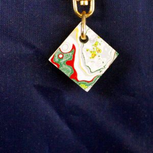 Colorful square pendant on blue background.