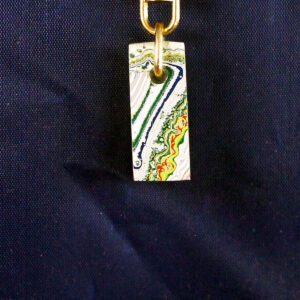 Colorful pendant with abstract design on chain.